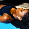 A woman practicing a body scan on a yoga mat.