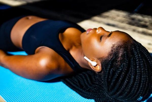 A woman practicing a body scan on a yoga mat.