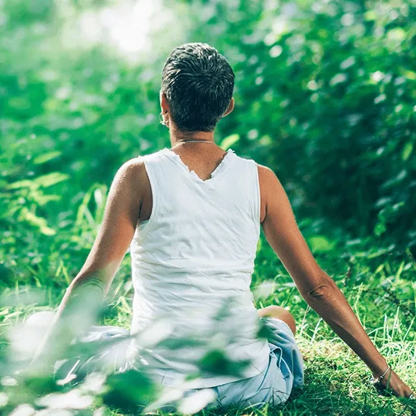 Woman practicing mindfulness in the serene forest.