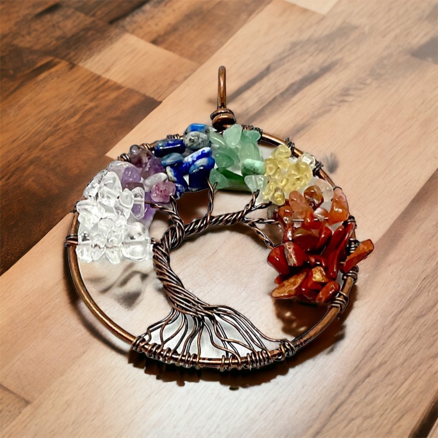 A colorful 7 chakra necklace pendant on a wooden table.