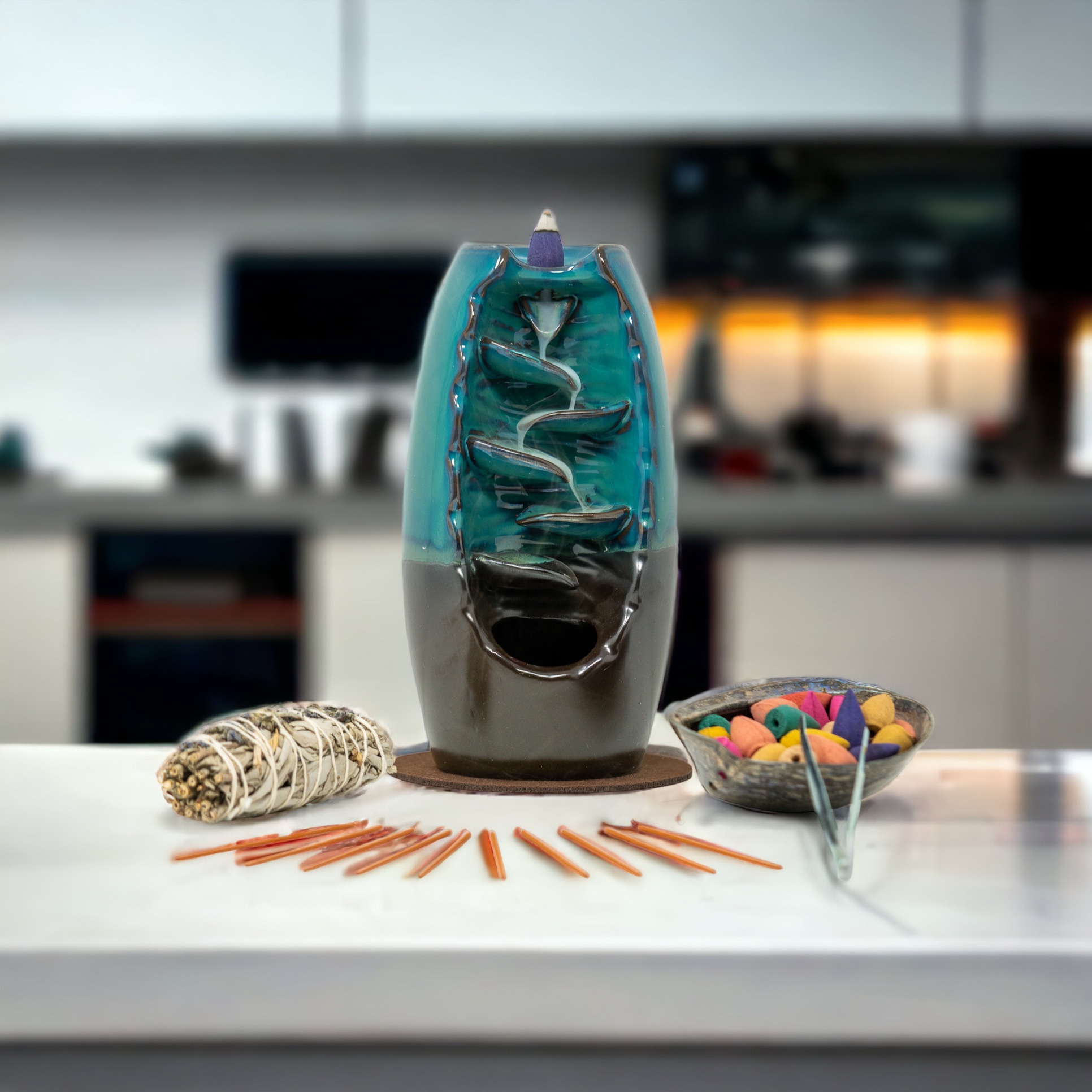 A home kitchen counter with a bowl of incense and a sage smudge stick