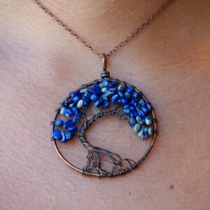 The woman is wearing a Lapis Lazuli Tree of Life Pendant.