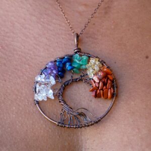 A woman is wearing a 7 Chakra Tree of Life Pendant.