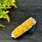 A 4" California White Sage Smudge with Sun Flower Petals adorned with sunflower petals on a wooden table.