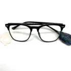 A pair of Blue Light Blocking Photochromic Transition Glasses- Black with a crystal and a rock.