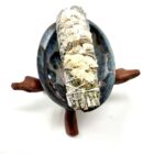 A 4" California White Sage Smudge Stick with White Sinuata Flowers in a blue bowl.