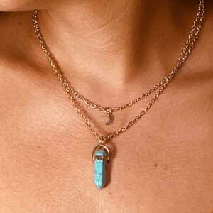 A woman adorned with a Turquoise with Moon Charm Natural Stone Necklace.