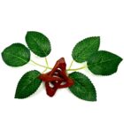 A red and green leaf on a 2" Wooden Tripod Stand.