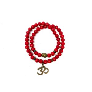 A Red Howlite Gemstone Bead Double Om Charm Bracelet with a double om charm on it.