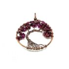 A vibrant Garnet Tree of Life pendant adorned with stunning purple stones.