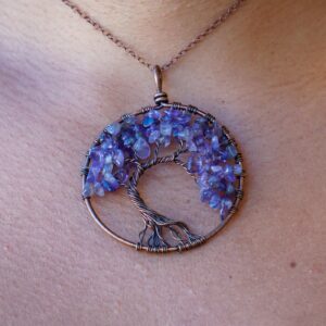 A woman is wearing an Amethyst Tree of Life Pendant.