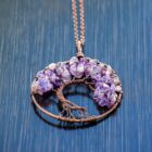 An Amethyst Tree of Life Pendant on a table.