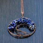 A Lapis Lazuli Tree of Life pendant featuring blue Lapis Lazuli stones.