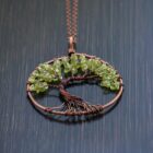 An Olive Quartz Tree of Life pendant necklace adorned with vibrant green peridots.