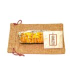 A 4" California White Sage Smudge with Sun Flower Petals wrapped in a pouch with a tag on it.