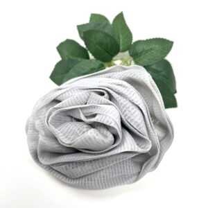 A Rose Loofah - Grey on a white surface.