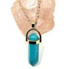 A Turquoise with Moon Charm Natural Stone Necklace pendant on a gold chain with a natural stone.