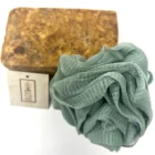 An African Black Soap bar paired with a loofah for exfoliation.