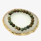 An Rhyolite Jasper bracelet on a gold plate.