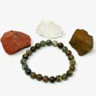 A beautiful Rhyolite Jasper Bracelet featuring vibrant red jasper, soothing green jasper, and sparkling crystals.