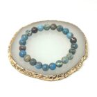 A Blue Sea Sediment Jasper Gemstone Bracelet, displayed on a gold tray.