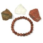 A Red Goldstone Gemstone Bracelet with red jasper beads and a rock.