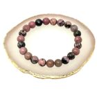 A Matrix Rhodonite Gemstone Bracelet on a gold plate.