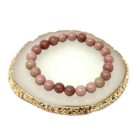 A Pink Rhodonite Gemstone Bracelet 8mm on a gold plate.