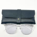 A pair of Blue Light Blocking Photochromic Glasses- Clear and a case on a white surface.