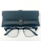 A pair of Blue Light Blocking Photochromic Glasses Vintage Style - Metal Frame- Black Temples and a case on a white surface.