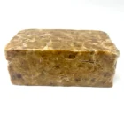 A block of African Black Soap on a white background.