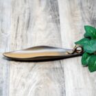 A metal leaf on a wooden table, accompanied by a Ceramic Incense Stick Holder| Incense Ash Catcher for Counters- Room- Office- Home Decor| Aromatherapy| Gift| FREE Incense with Order.