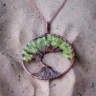 A copper Olive Quartz Tree of Life pendant necklace with olive green stones.