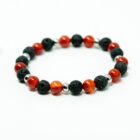 A red and black gemstone crystal bracelet with carnelian, lava, and silver stainless steel spacers.