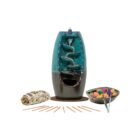 A Turquoise Ceramic Waterfall Backflow Incense Burner with Mixed Incense Cones, Sticks & Sage vase with a bowl of candy and a bowl of sticks.